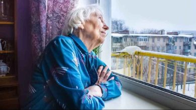 depositphotos 240433906 stock photo old lonely woman sitting window 1